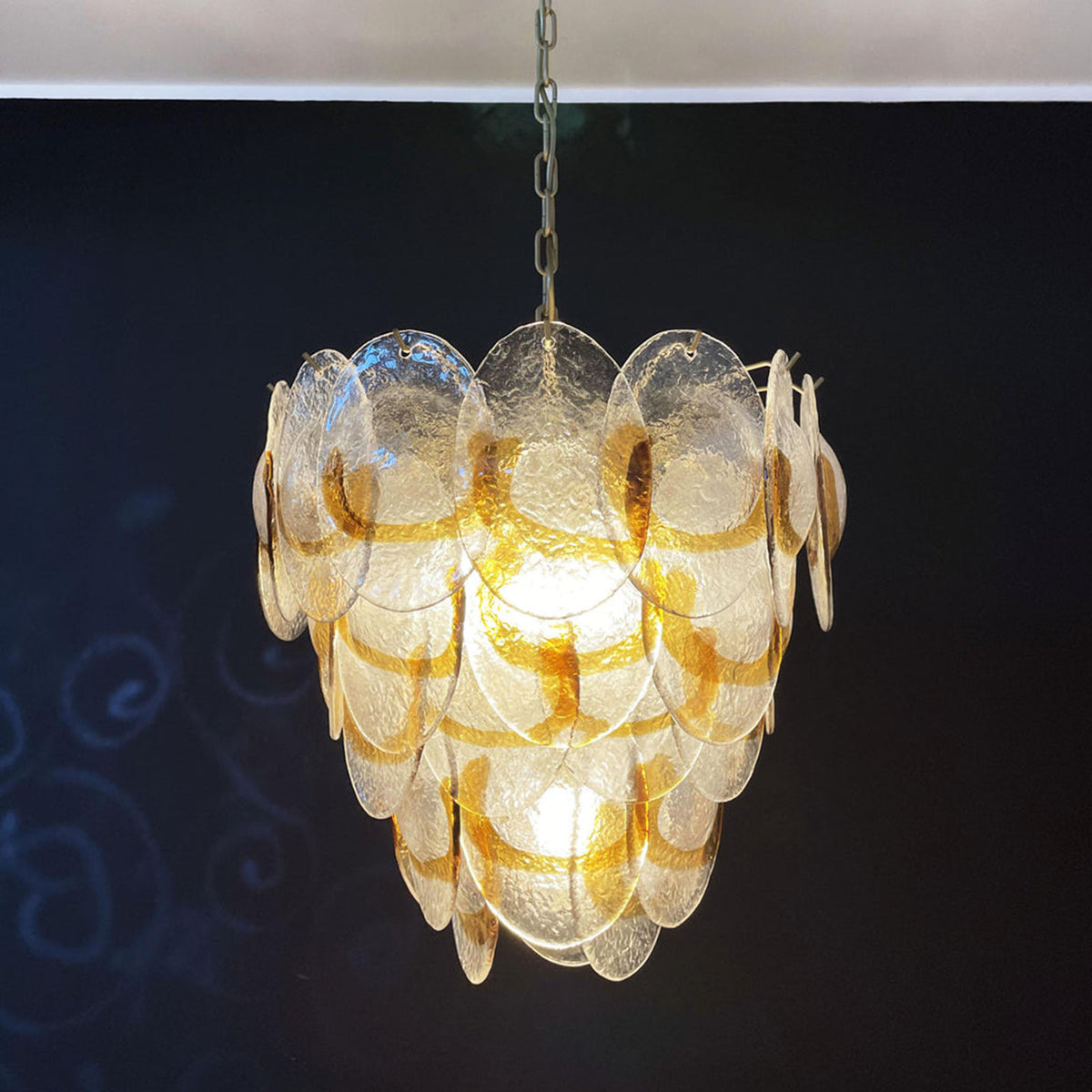 Close-up of overlapping glass discs on the Mazzega-style chandelier, showing their layered arrangement.