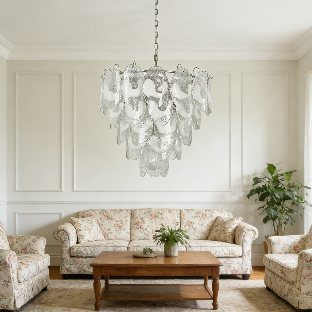 Mazzega-style white glass chandelier hanging in a bright cream-toned living room with neutral sofas.