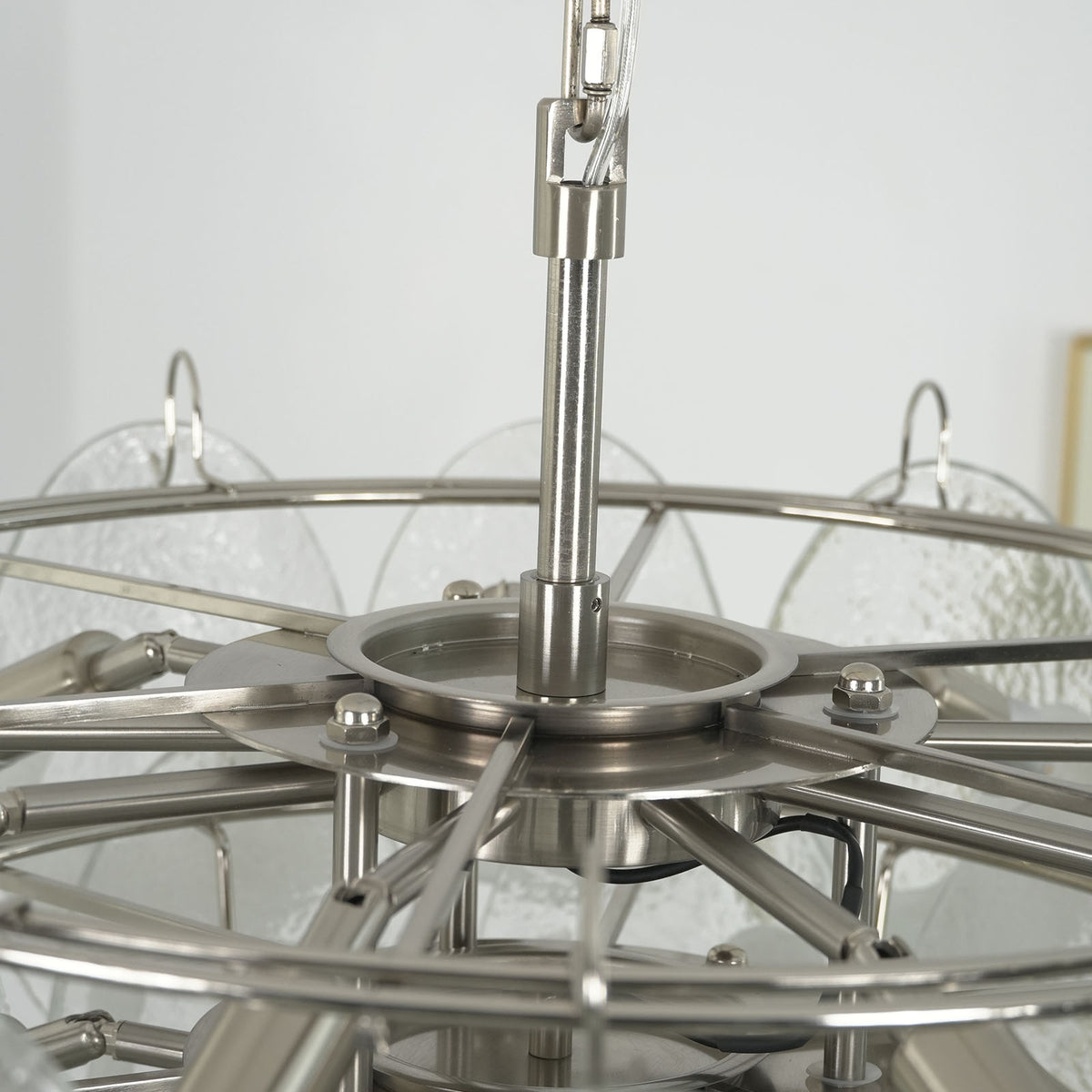 Close-up of overlapping textured glass discs on the lit Mazzega-style chandelier, highlighting their glow.