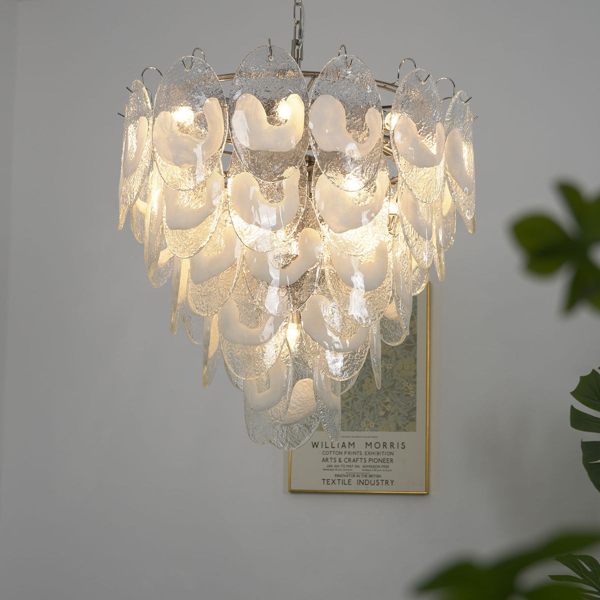 Low-angle view of a lit Mazzega-style white glass chandelier, highlighting its glowing textured glass.