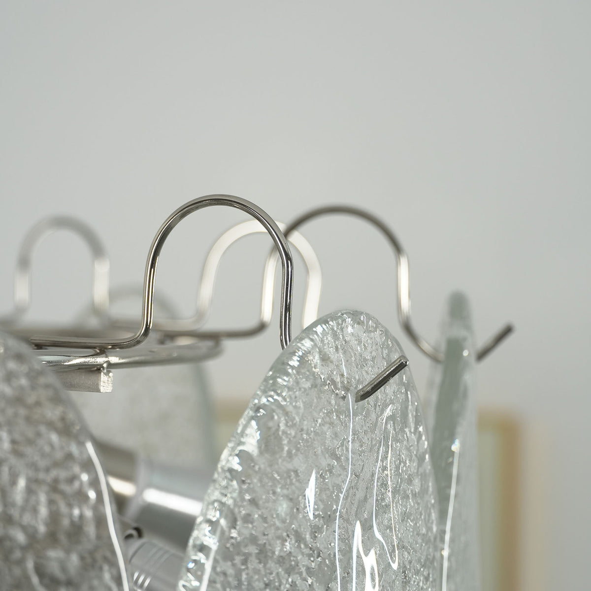 Side view of the Mazzega-style white glass chandelier on a white background, highlighting its tiered silhouette.