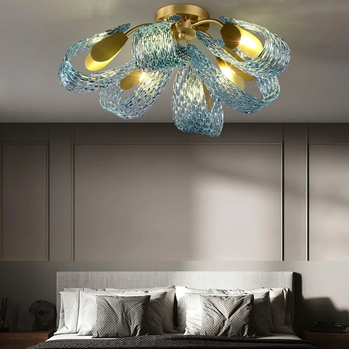 Petal blue glass ceiling light installed in a modern bedroom with neutral decor and upholstered bed.
