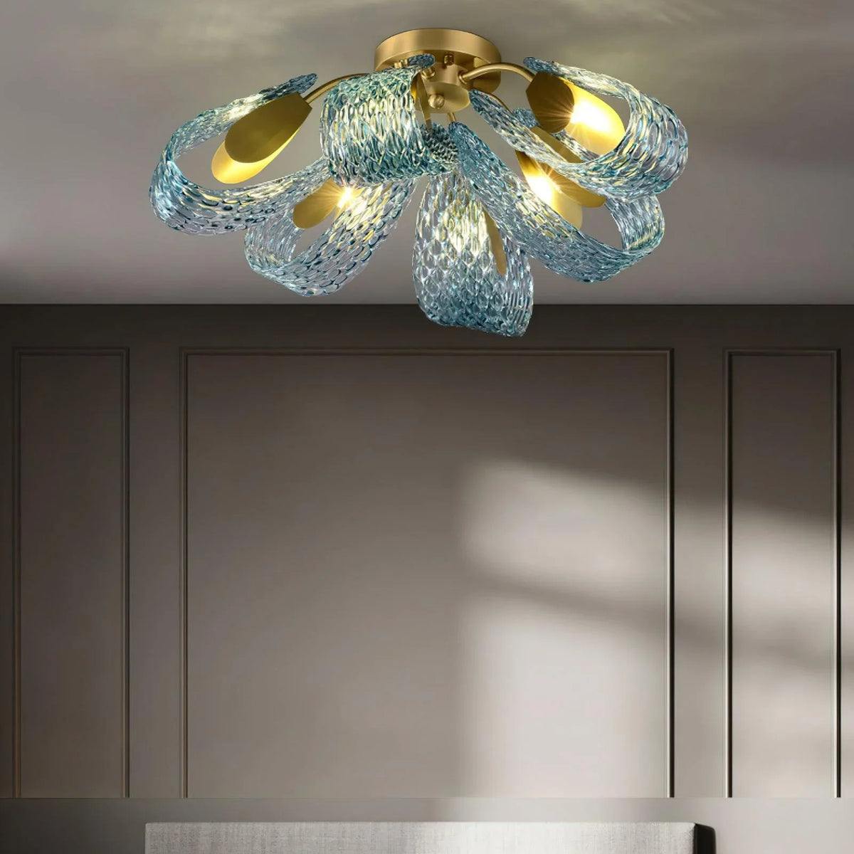 Petal blue glass ceiling light installed in a contemporary bedroom with neutral tones.