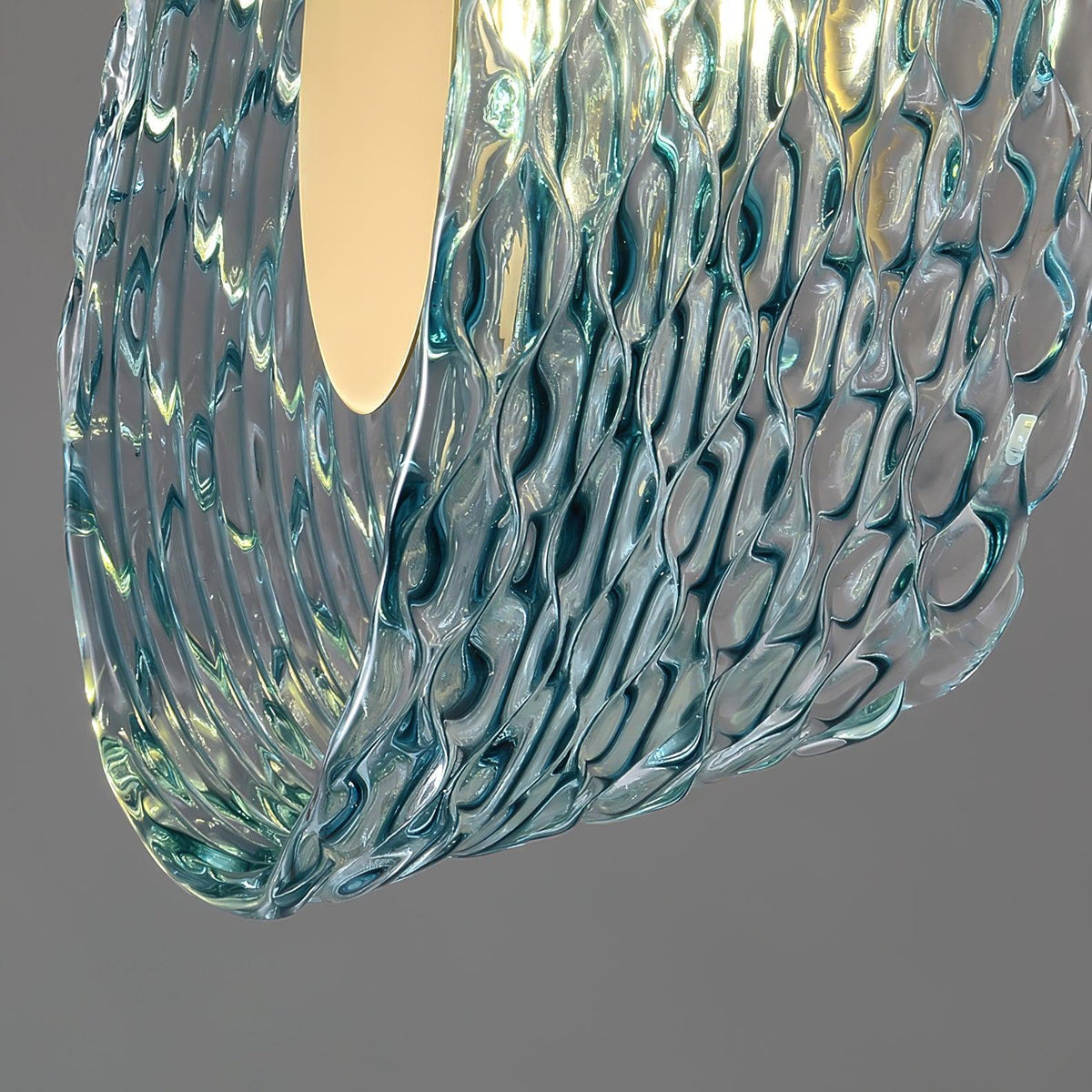 Close-up of the textured wavy surface on the blue glass petals of the ceiling light.