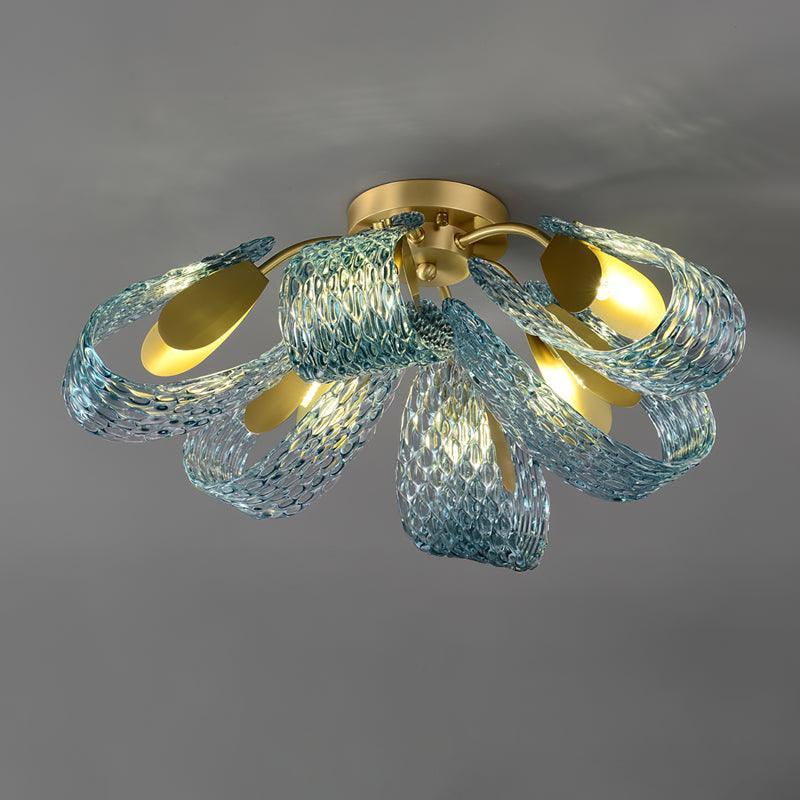Side view of the lit petal blue glass ceiling light, showing the glowing translucent blue glass petals.