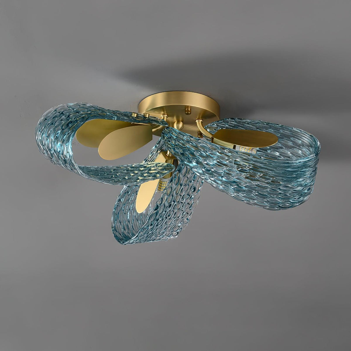 Side view of the petal blue glass ceiling light on a plain white background, showing its profile.