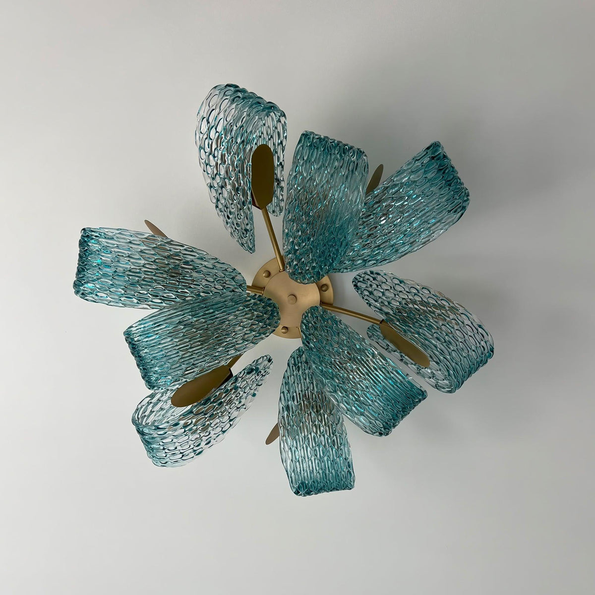 Top-down view of the petal blue glass ceiling light, showing its flower-like arrangement on a plain white background.