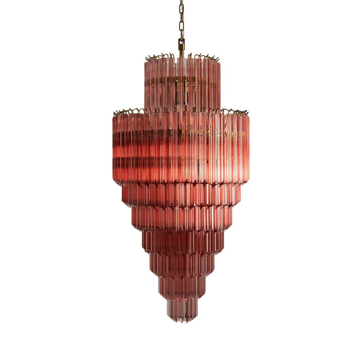 Pink glass tiered Murano style chandelier isolated on a plain white background.