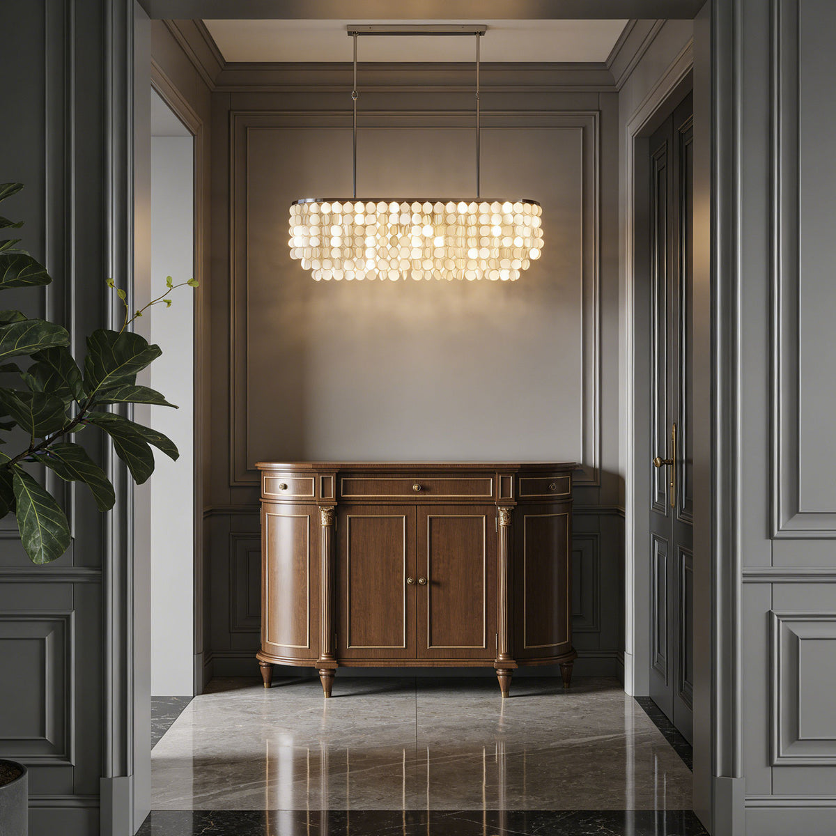Rectangular capiz shell chandelier hanging in a grand entryway above a dark wooden console.