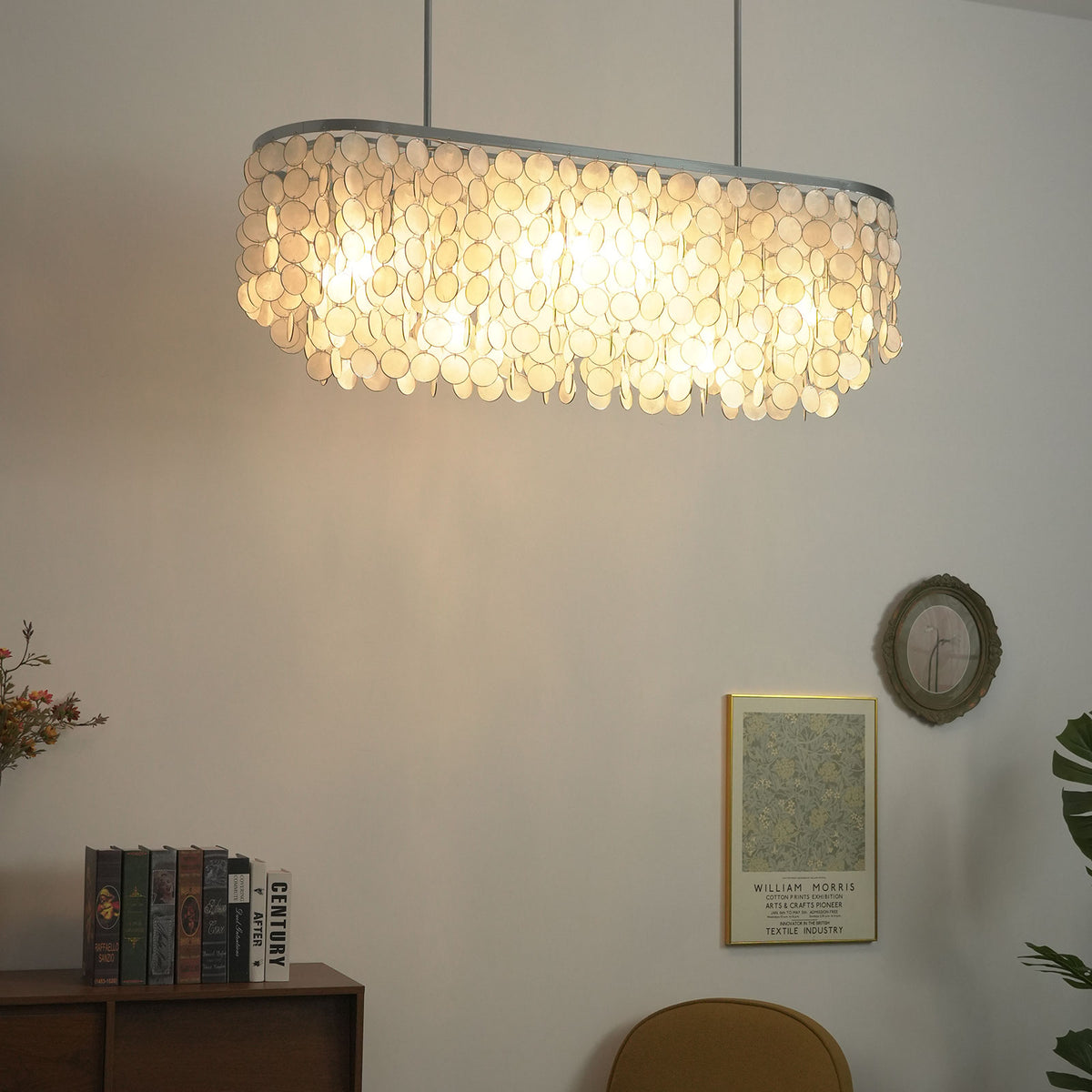 Front view of a lit rectangular capiz shell chandelier, highlighting its symmetrical cascading design.