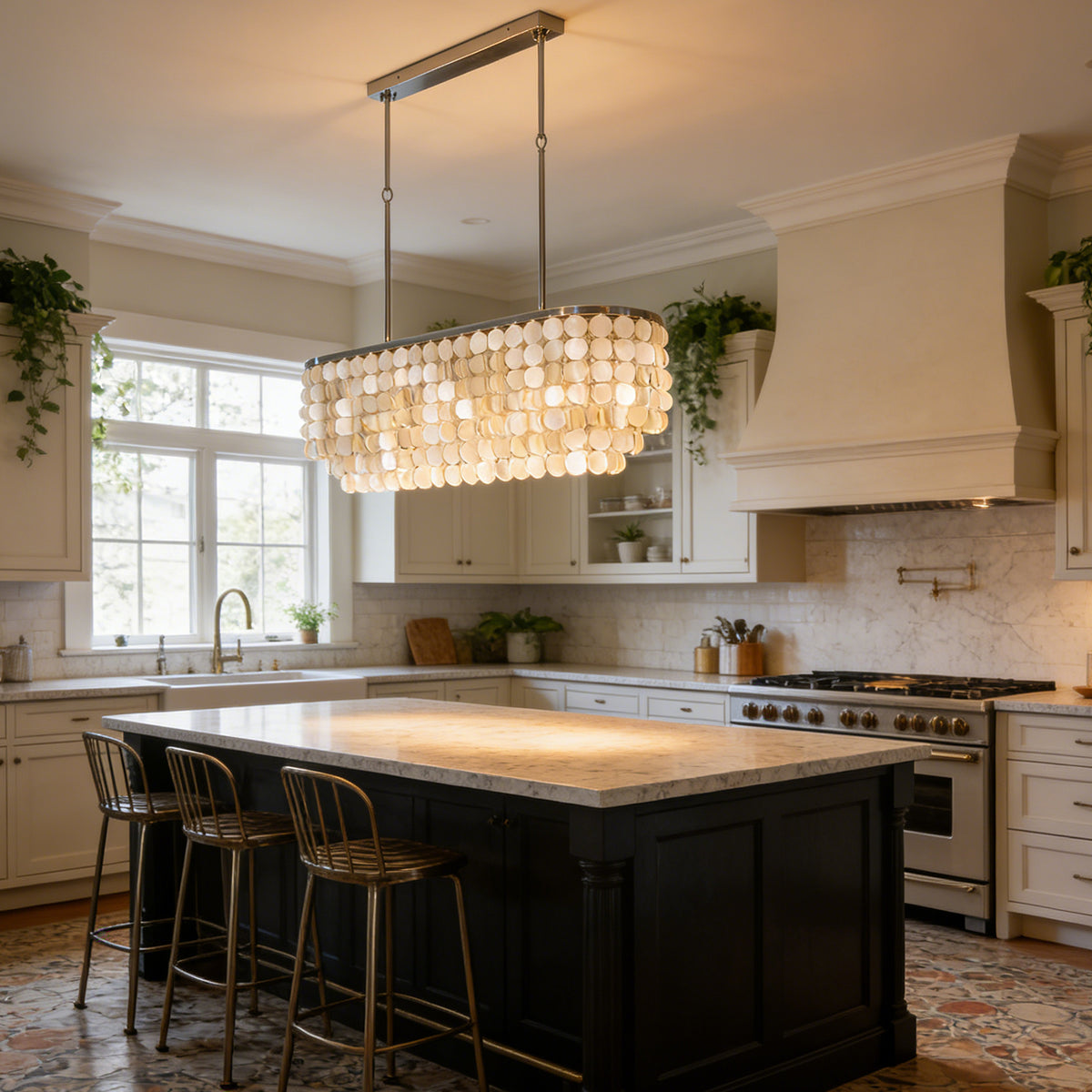 Rectangular capiz shell chandelier hanging above a black kitchen island in a bright white kitchen.