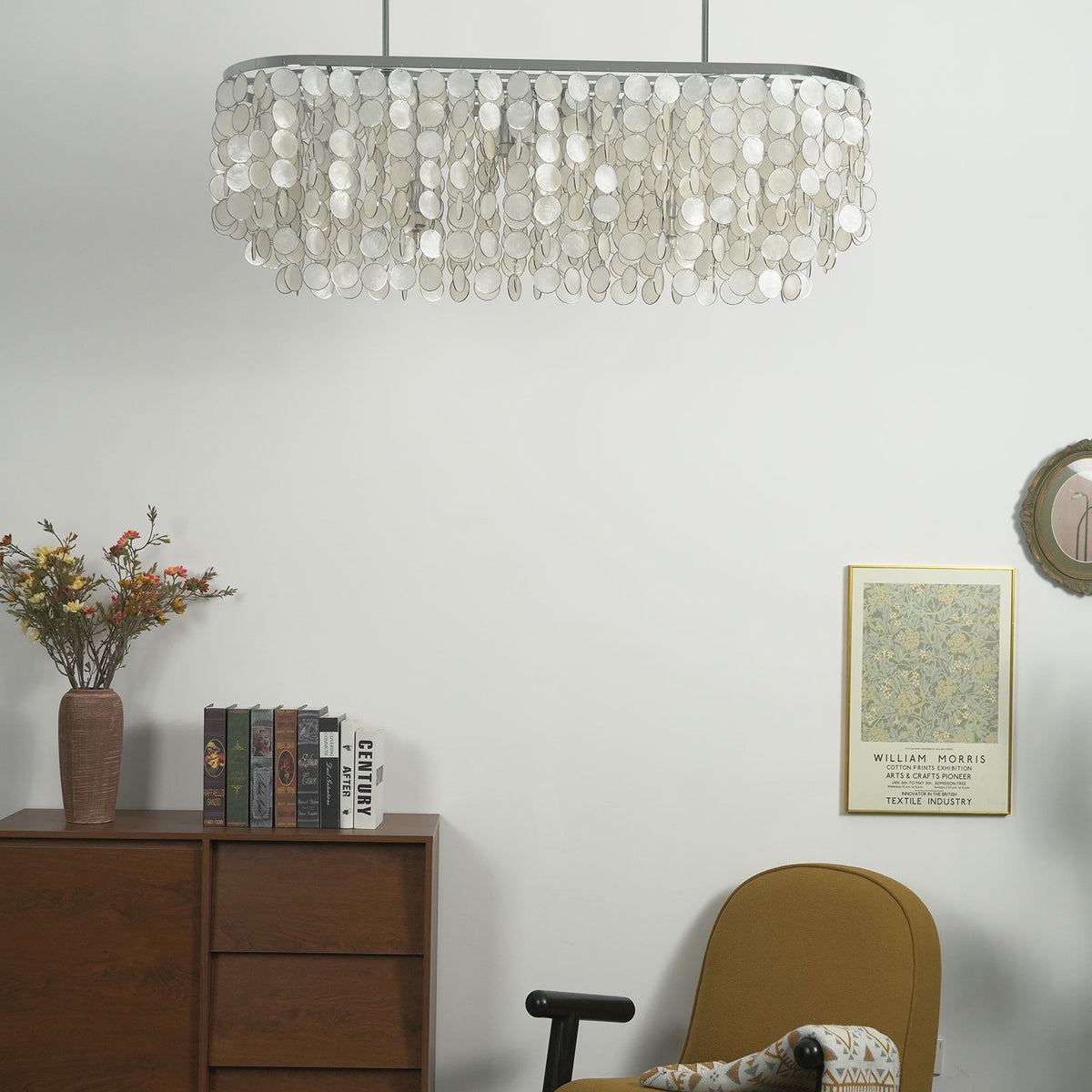 Lit rectangular capiz shell chandelier showing the soft, diffused glow through each shell disc.