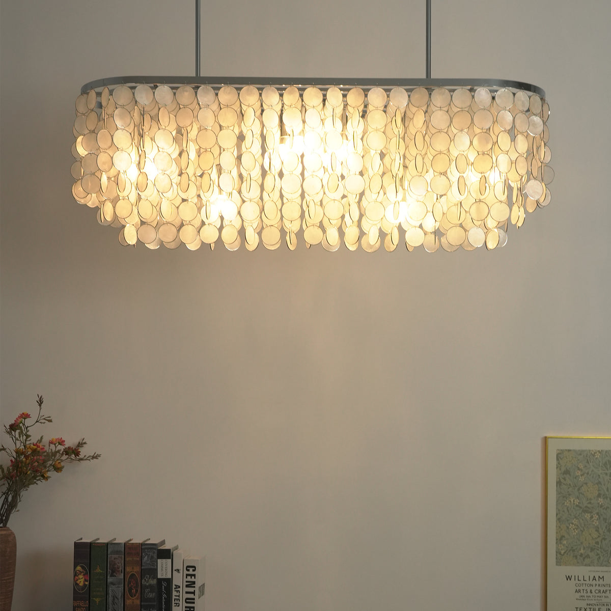 Low-angle view of a lit rectangular capiz shell chandelier, highlighting its glowing shell discs.