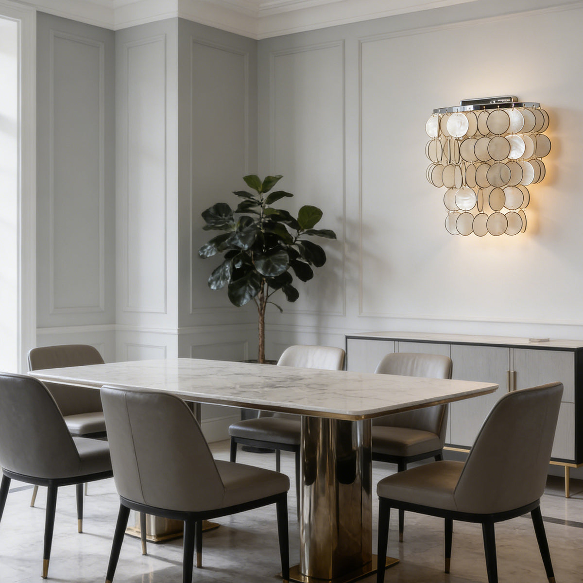 Round tiered capiz shell wall sconce mounted above a light gray sofa in a minimalist living room.