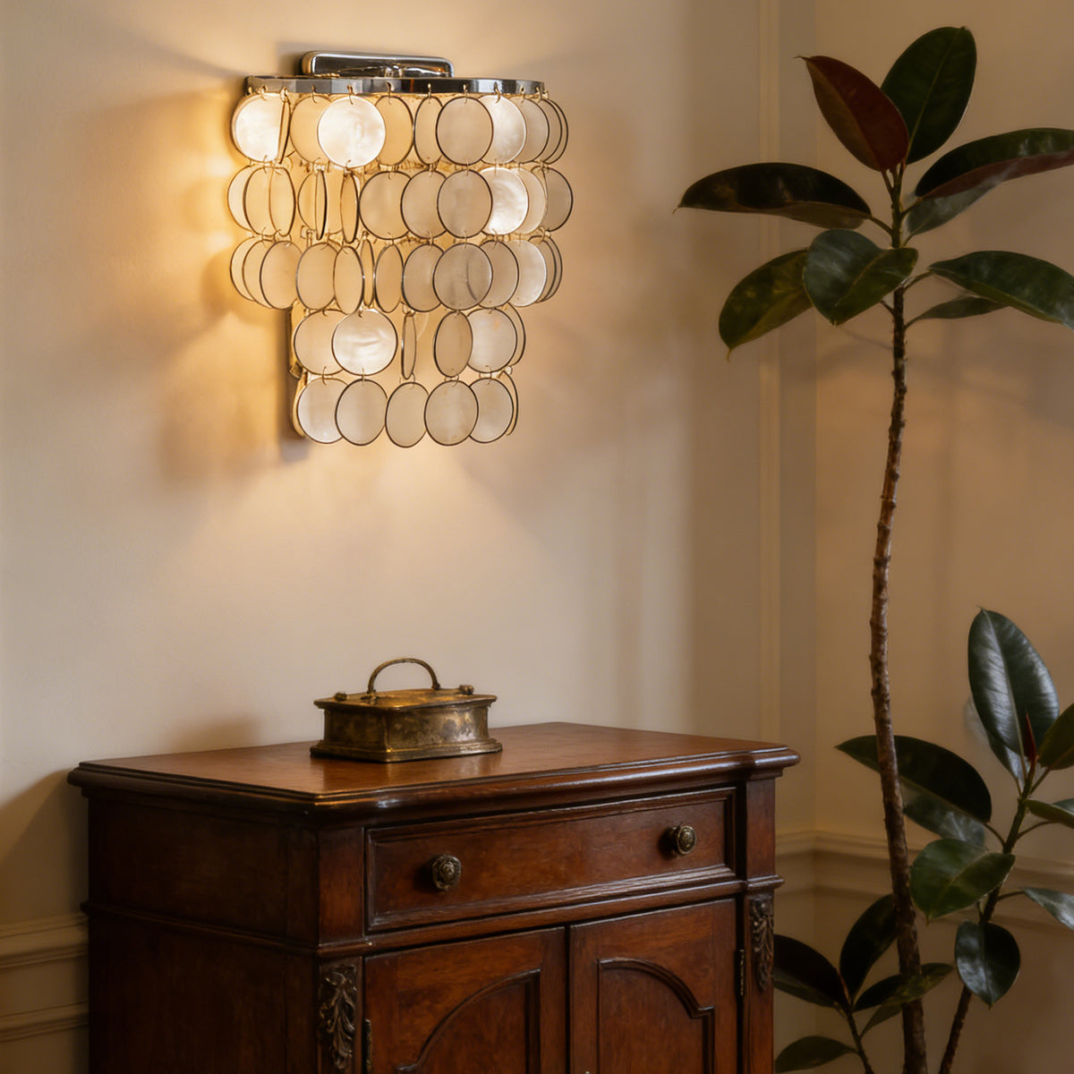 Round tiered capiz shell wall sconce in a bright modern dining room with light walls.