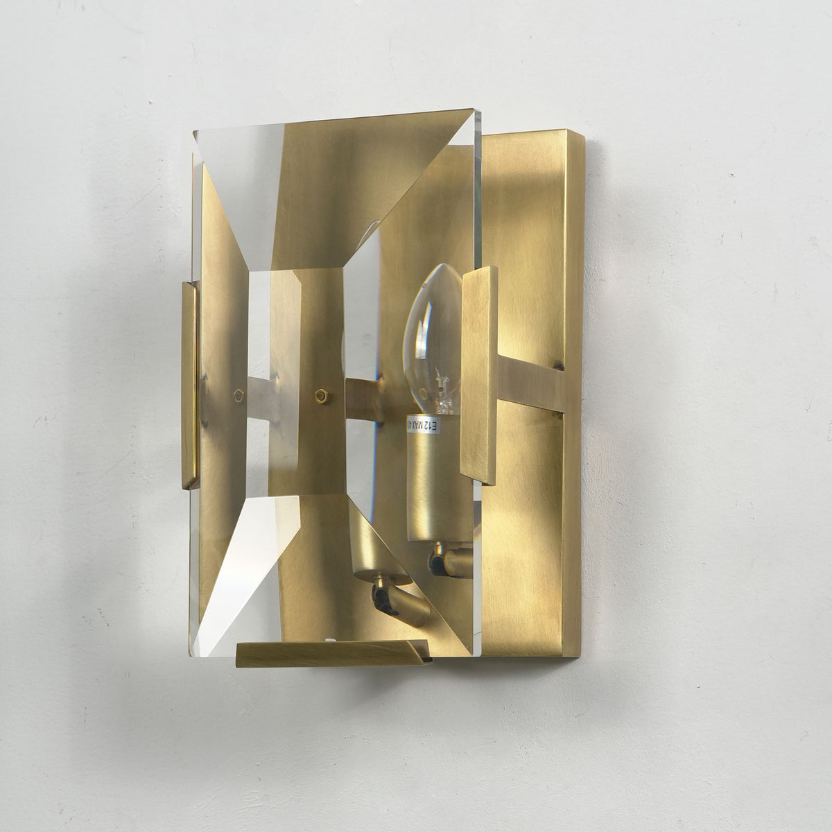 Single-headed crystal wall lamp with black frame, isolated on a plain white background.