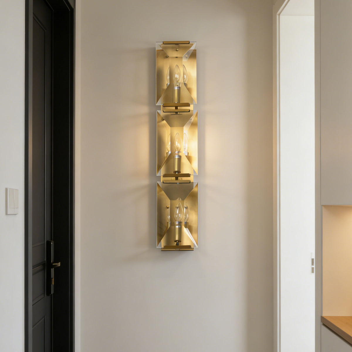 Black frame variant of the three-headed crystal wall lamp mounted on a plain white wall.