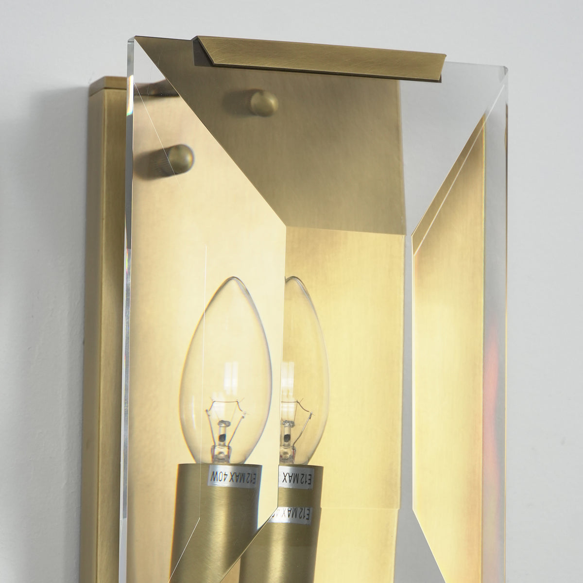 Close-up of the bulb socket and internal crystal structure on the three-headed wall lamp.