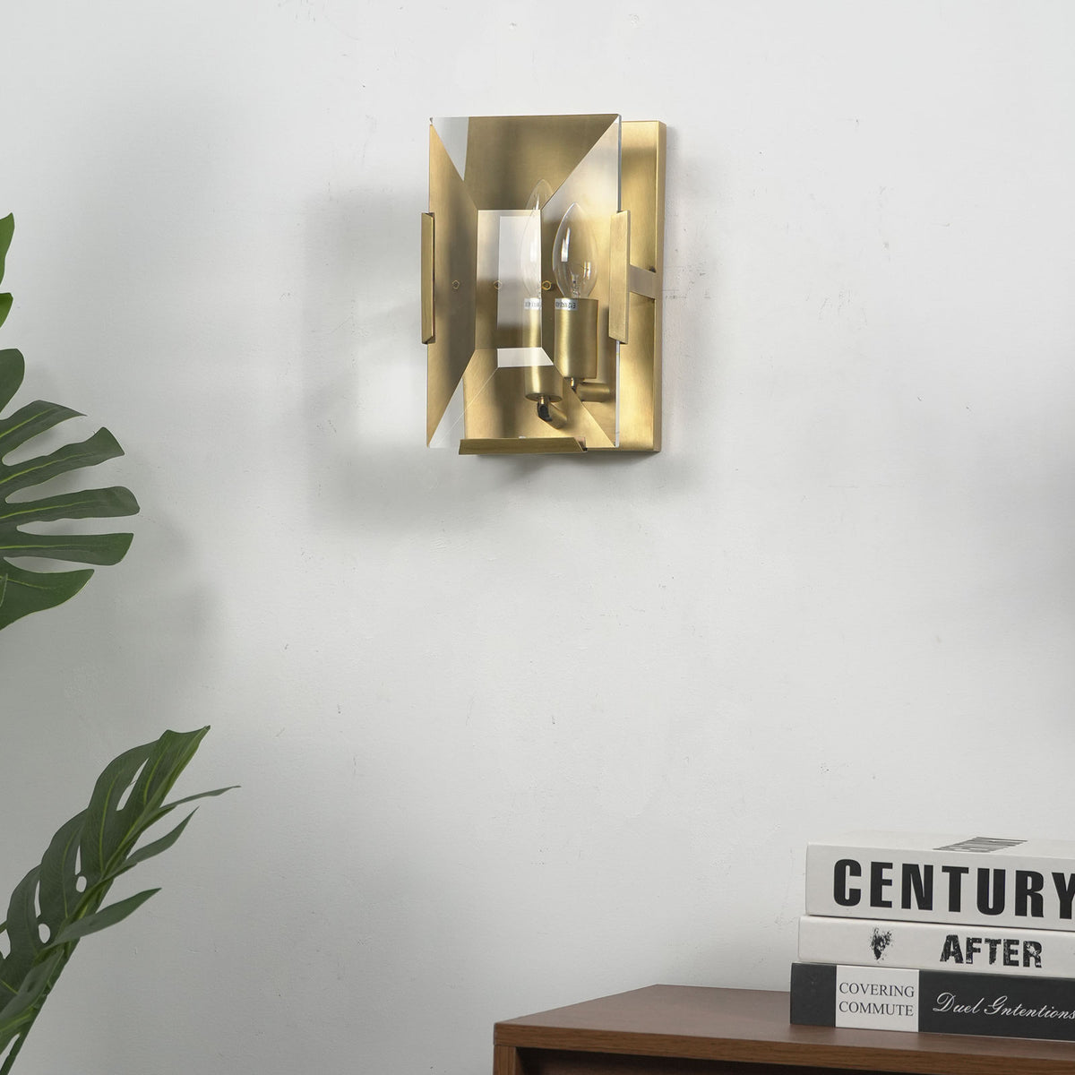 Three-headed crystal wall lamp mounted beside a wooden door in a modern entryway.