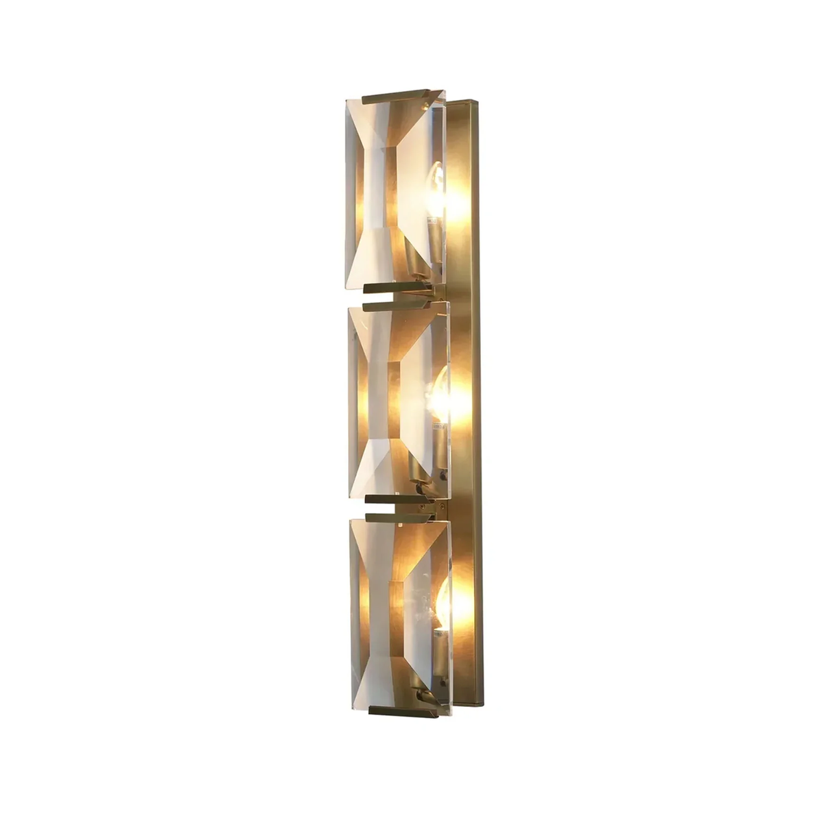 Three-headed crystal wall lamp with brass frame and faceted crystal panels, isolated on a plain white background.