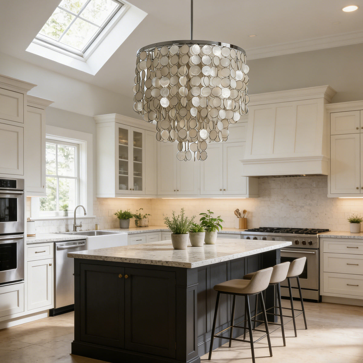 Tiered capiz shell chandelier hanging above a black kitchen island in a bright white kitchen.