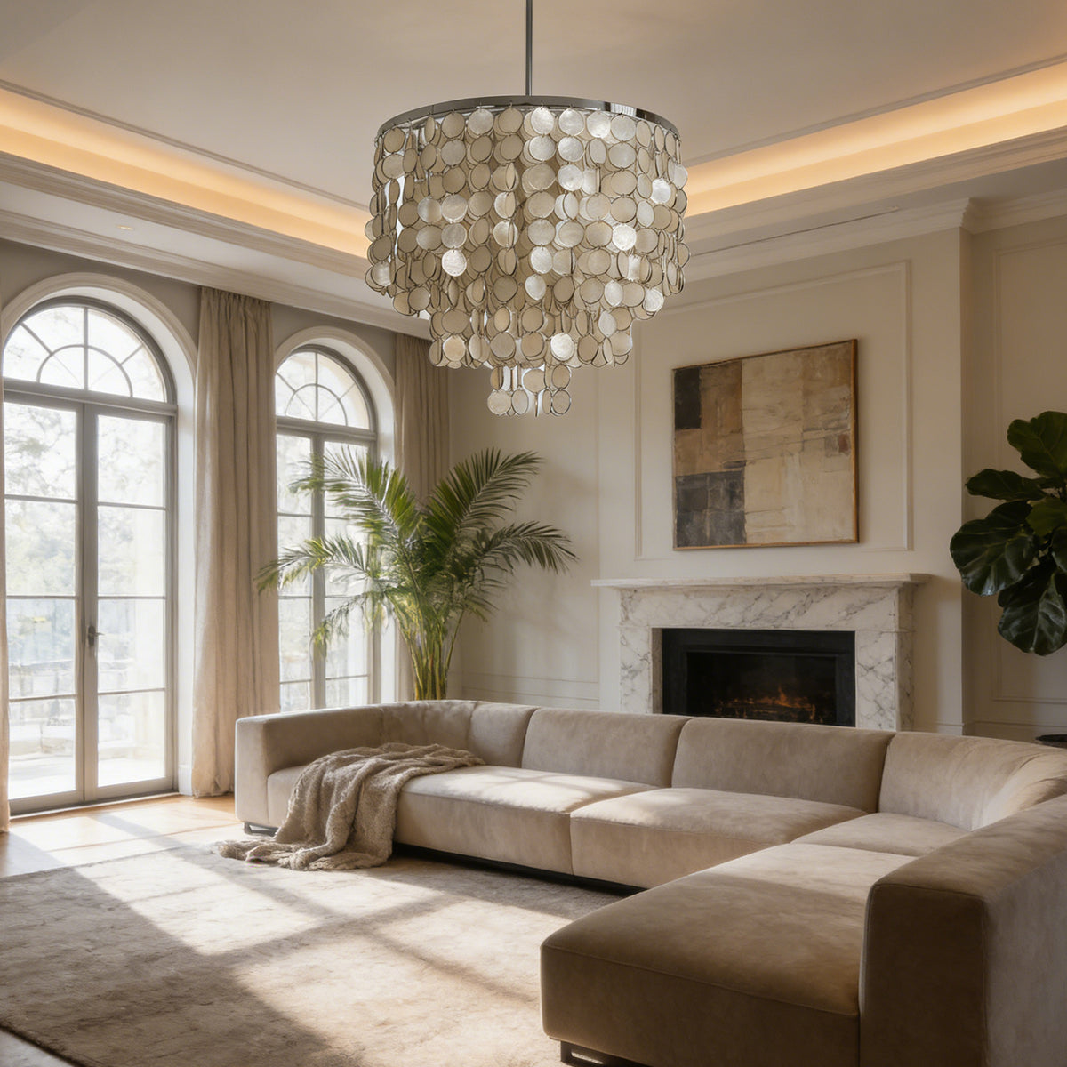 Tiered capiz shell chandelier in a sunlit living room with a curved beige sofa and fireplace.