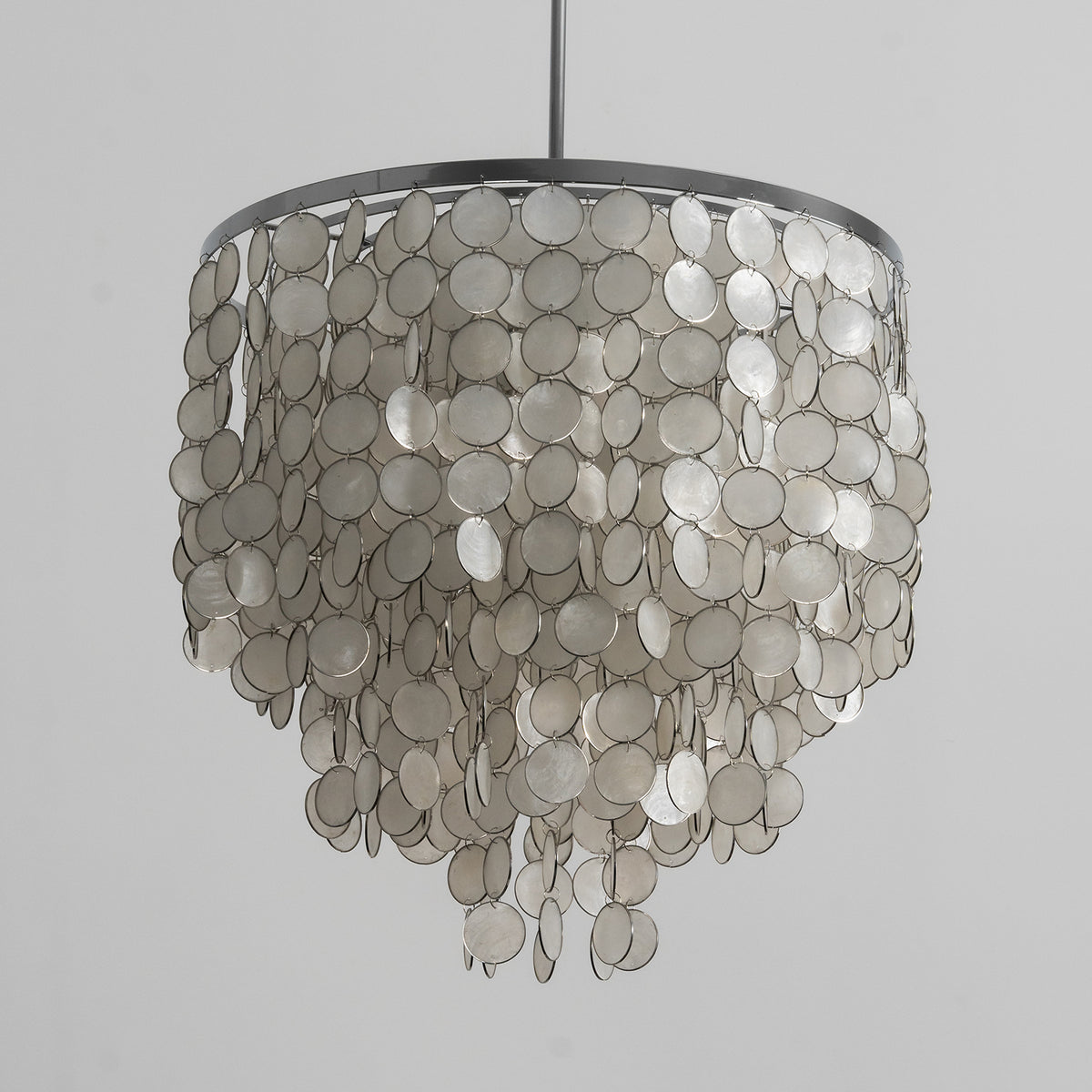 Side view of the tiered capiz shell chandelier, isolated on a white background to show its full silhouette.