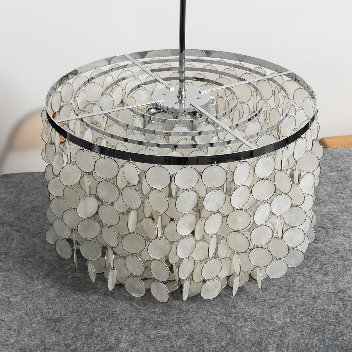 Top-down view of the tiered capiz shell chandelier, revealing its metal frame and layered shell arrangement.
