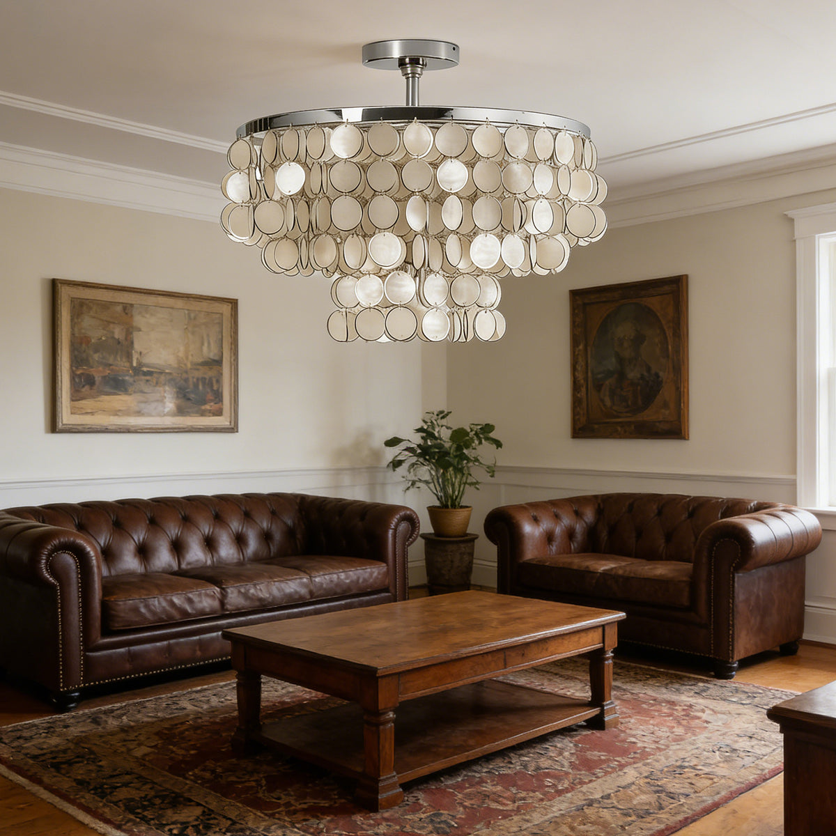 Tiered shell disc ceiling light in a cozy living room with brown leather sofas and a wooden coffee table.