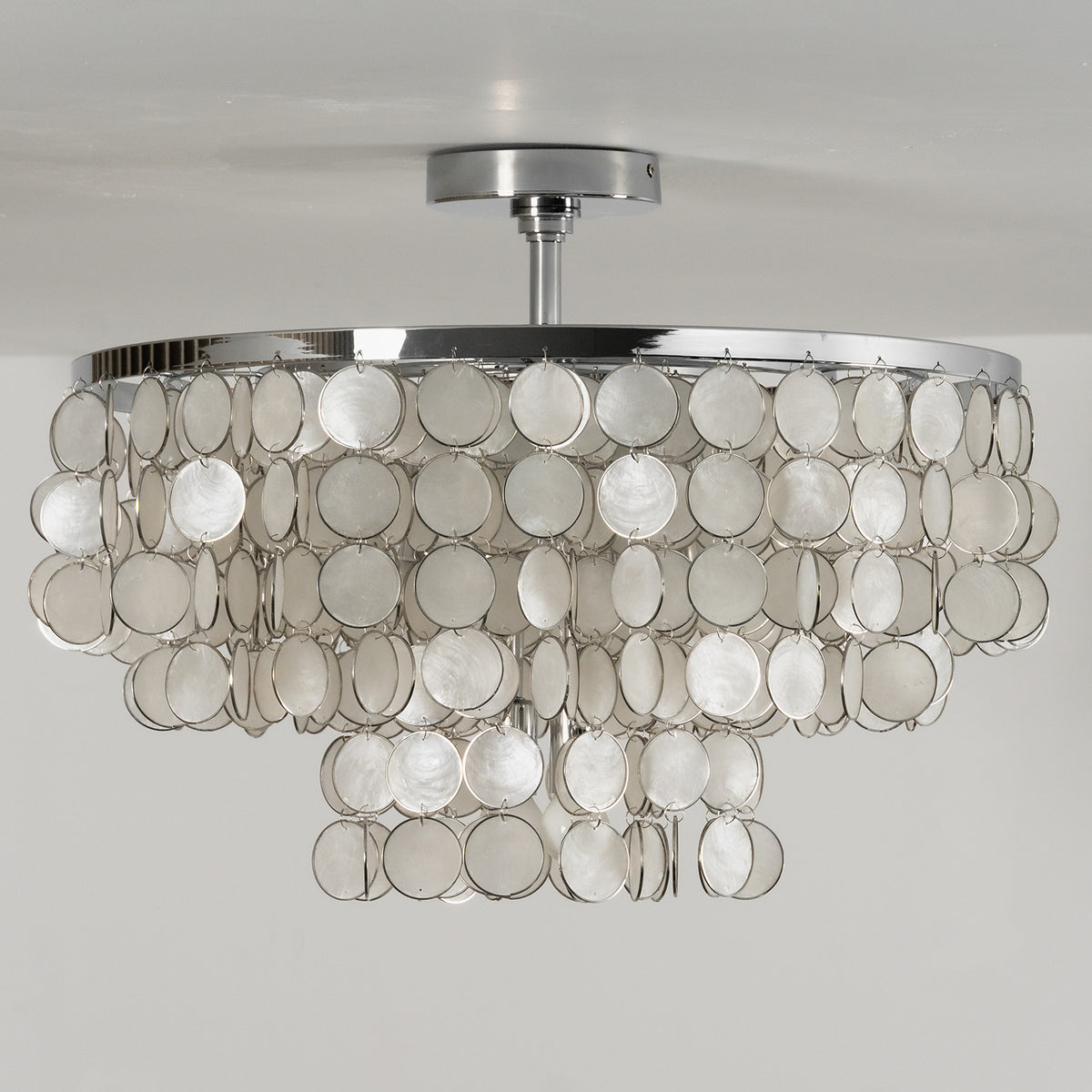 Front view of the tiered shell disc ceiling light against a plain white background, showing its full shape.