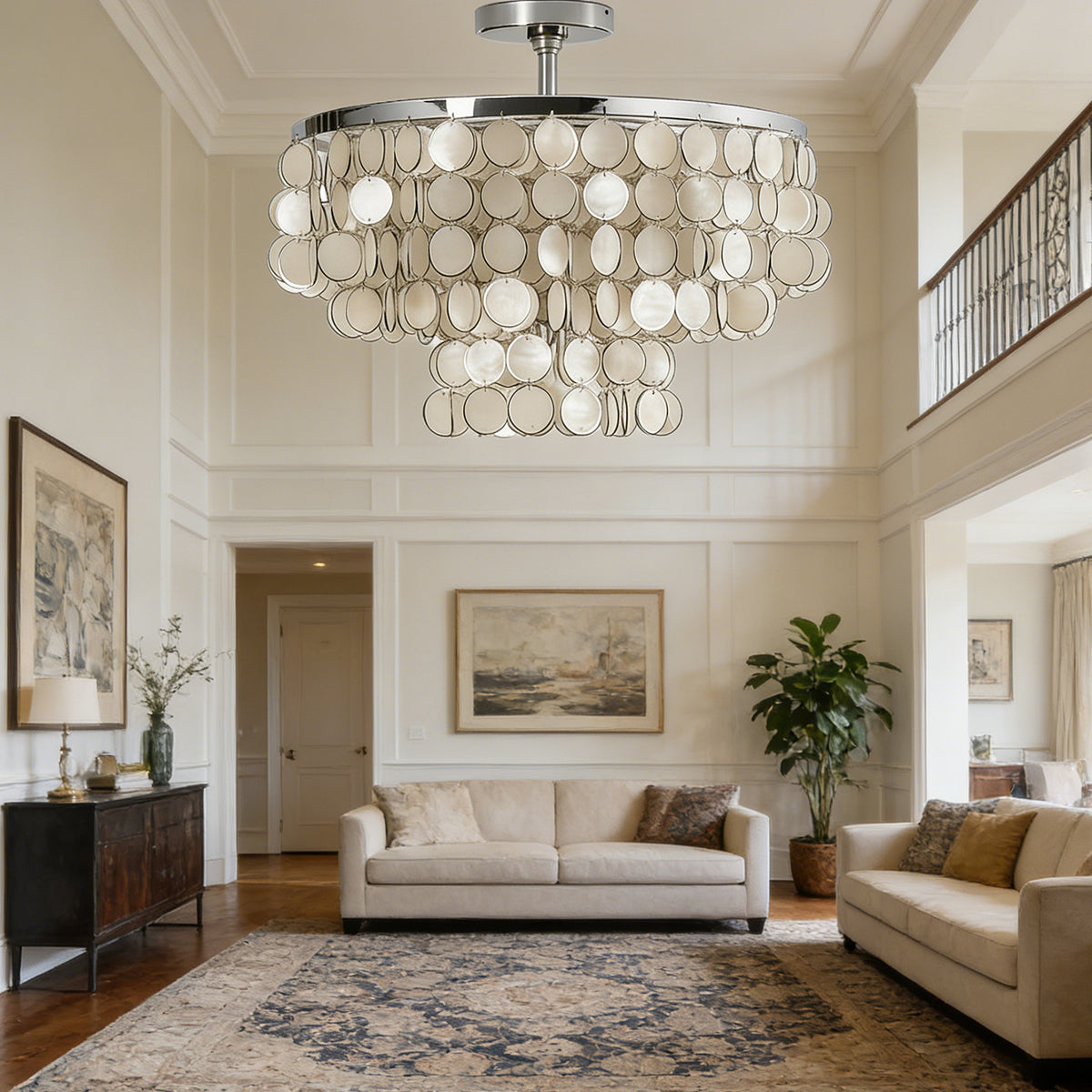 Tiered shell disc ceiling light in a grand two-story entryway with light neutral walls.
