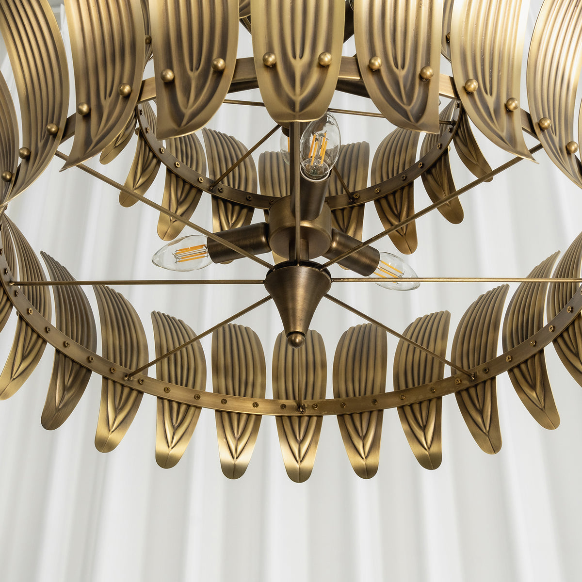 Angled view of the vintage brass leaf chandelier showing its full layered silhouette.