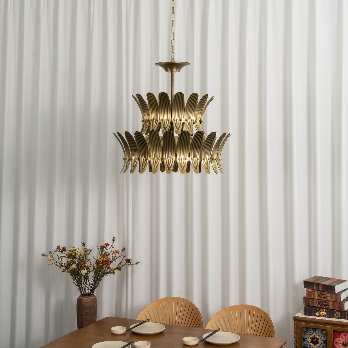 Close-up view of the textured brass leaf details on the vintage chandelier.