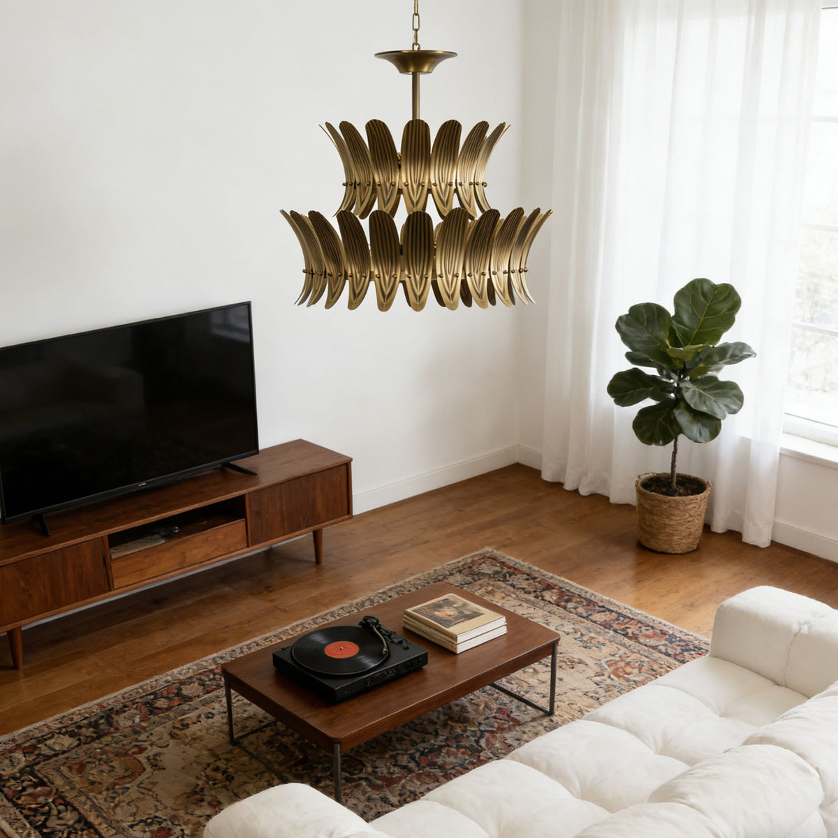Vintage brass leaf chandelier in a cozy living room with a low TV console and white sofa.