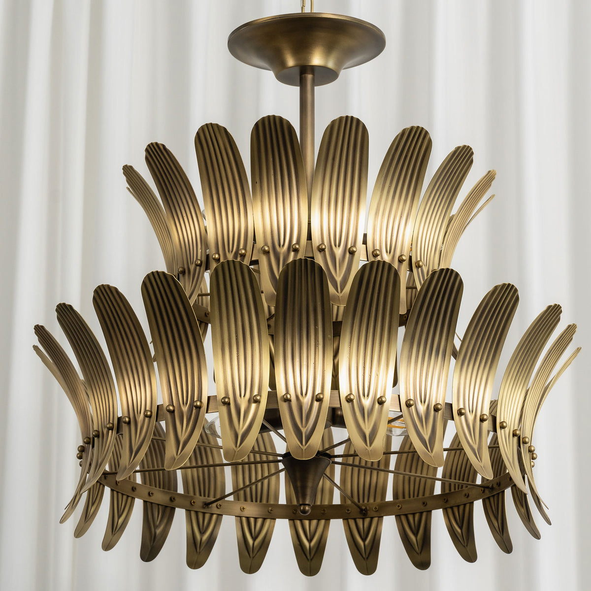 View of the vintage brass leaf chandelier from below, showing its metal frame and leaf arrangement.