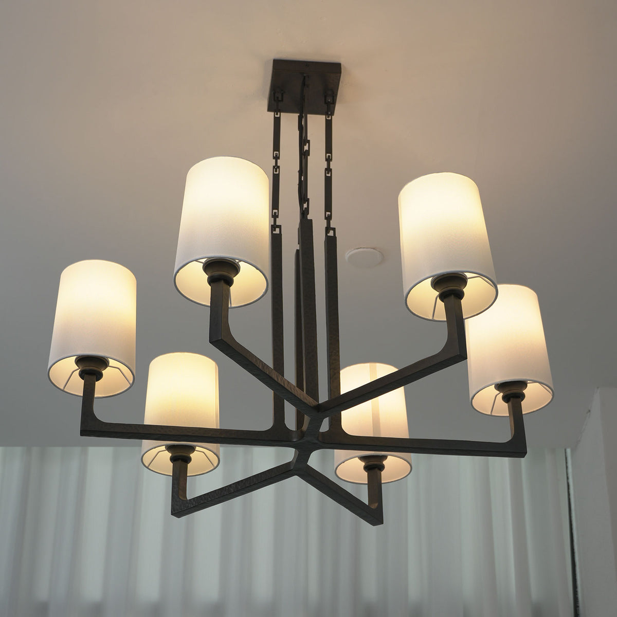 Close-up of the decorative metal chain links on the hanging rod of the Wright-inspired chandelier.