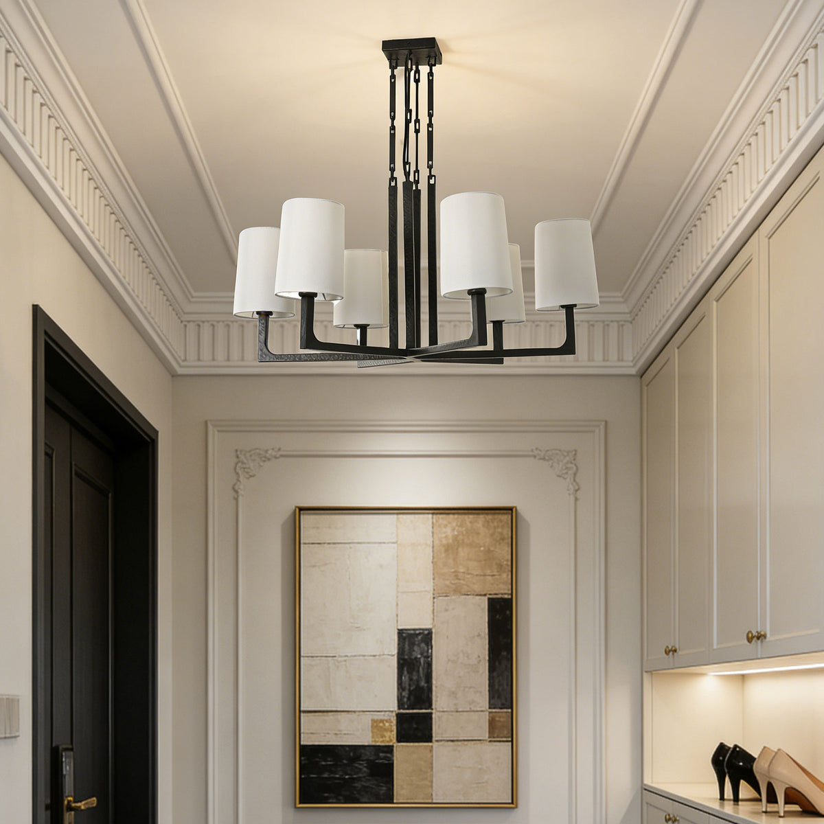 Wright-inspired round chandelier hanging in a high-ceiling dining area with sheer white curtains.