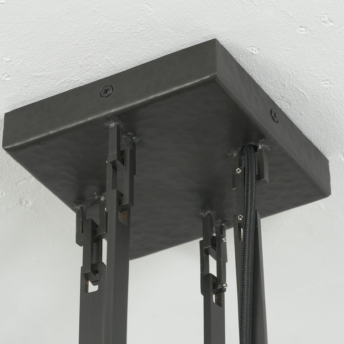 Close-up of the decorative link connectors on the hanging rod of the Wright-inspired chandelier.