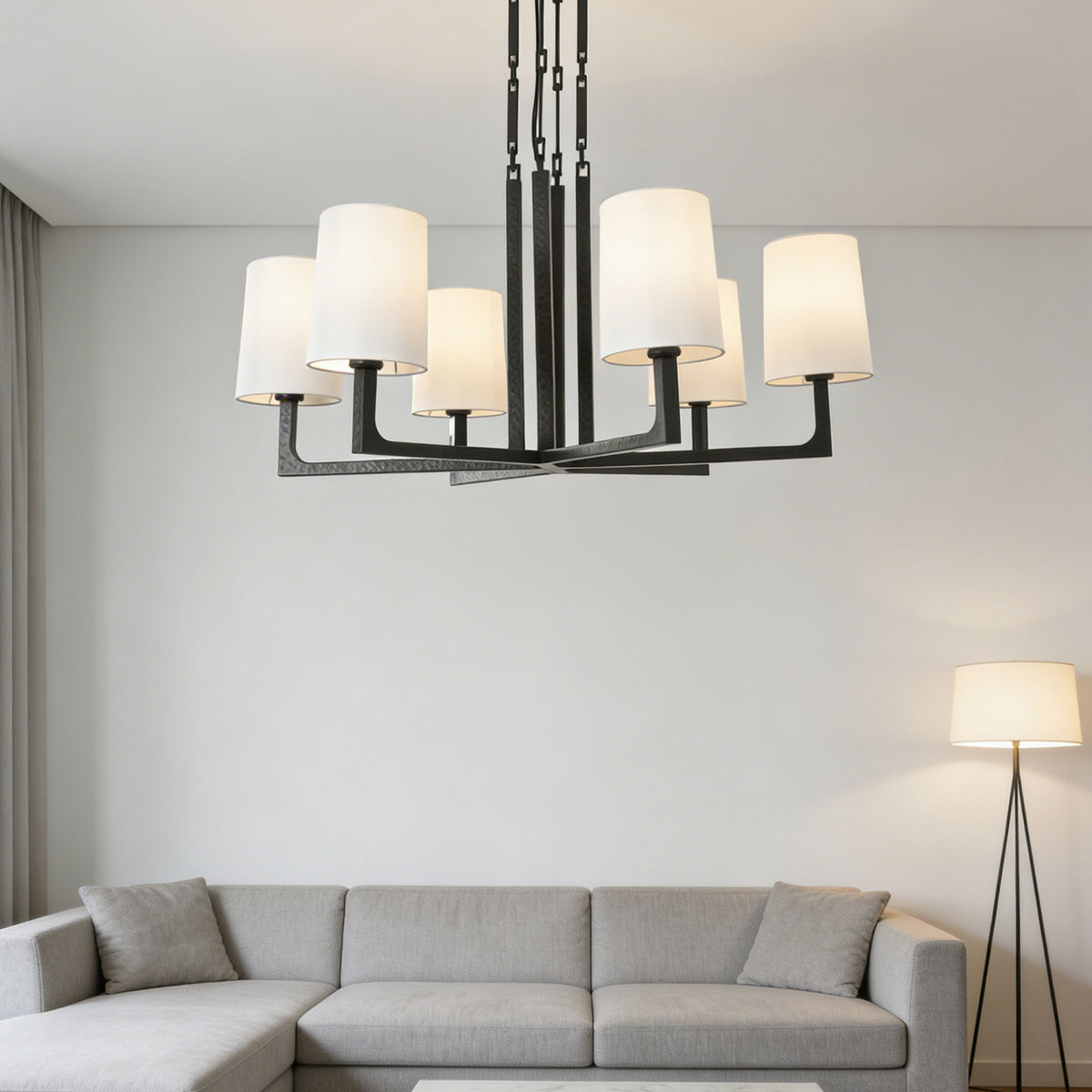 Wright-inspired round chandelier hanging above a light gray sofa in a bright modern living room.