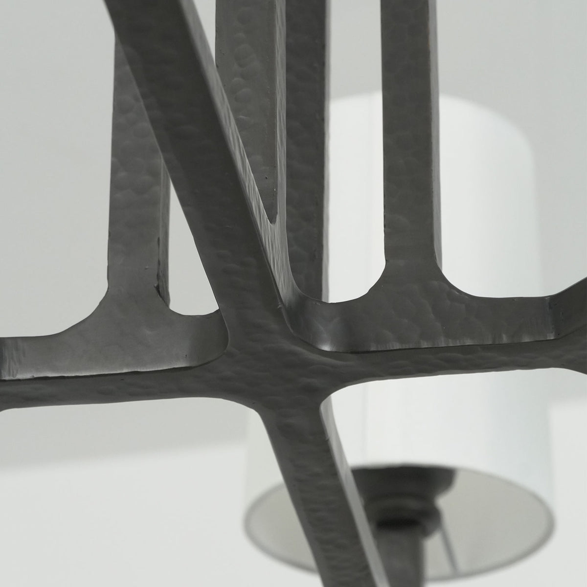 Close-up of the white fabric lampshade interior and black metal socket on the Wright-inspired chandelier.
