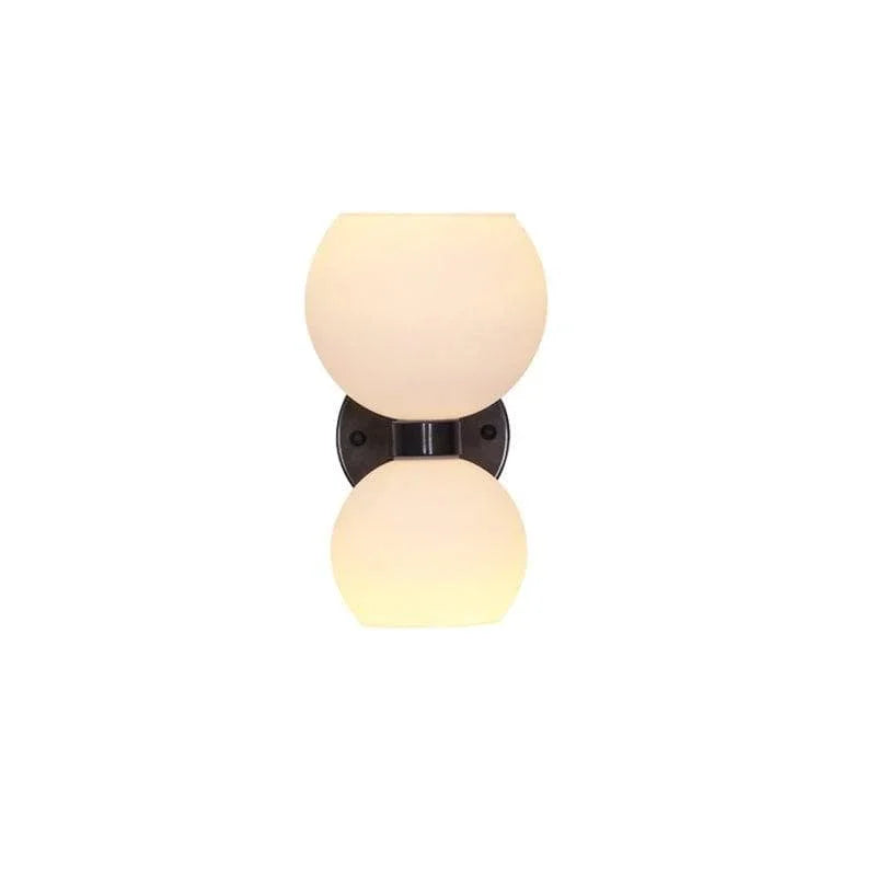Modern wall sconce with frosted glass globes and black metal base for stylish home lighting