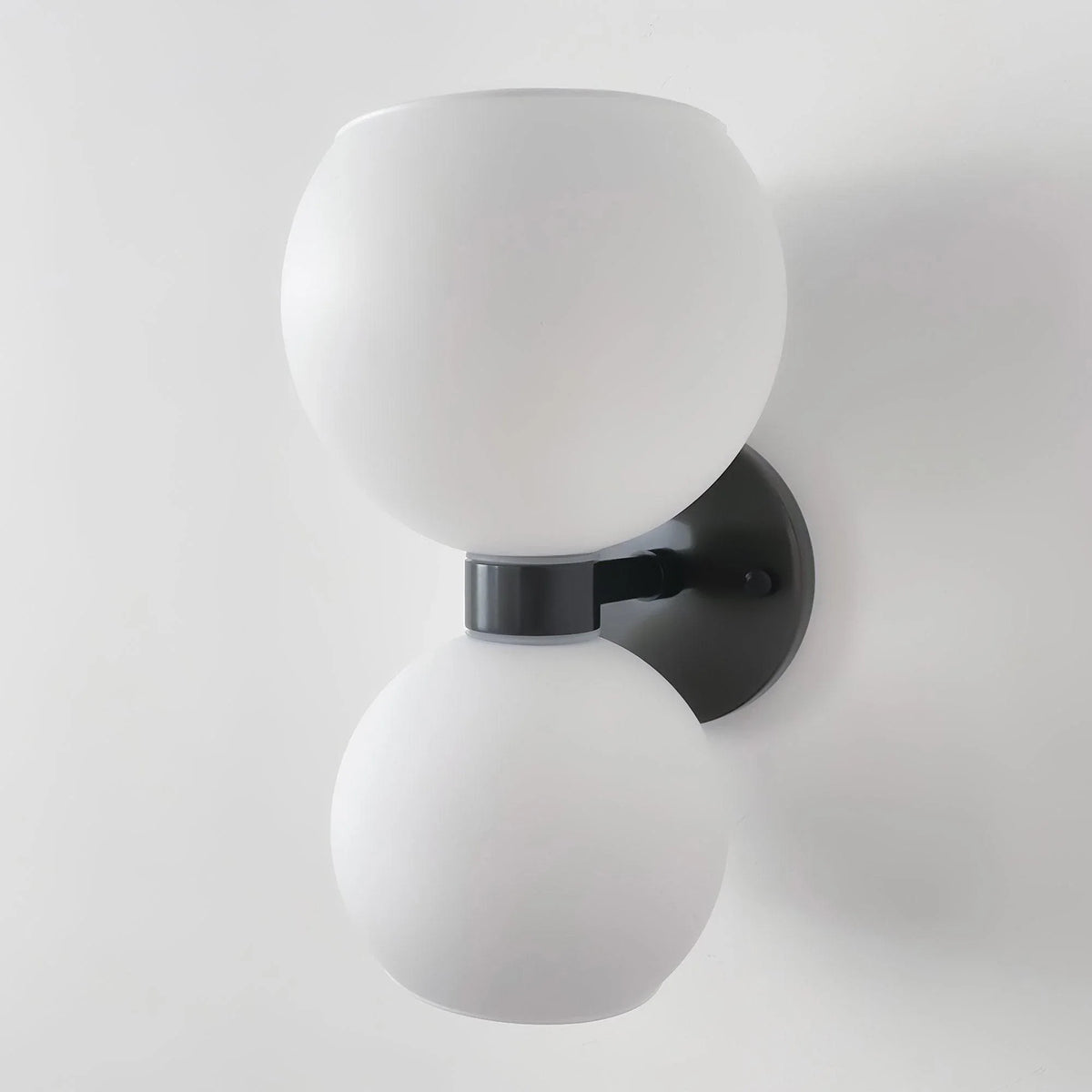 Modern wall sconce with dual frosted glass globes and matte black fixture for contemporary lighting