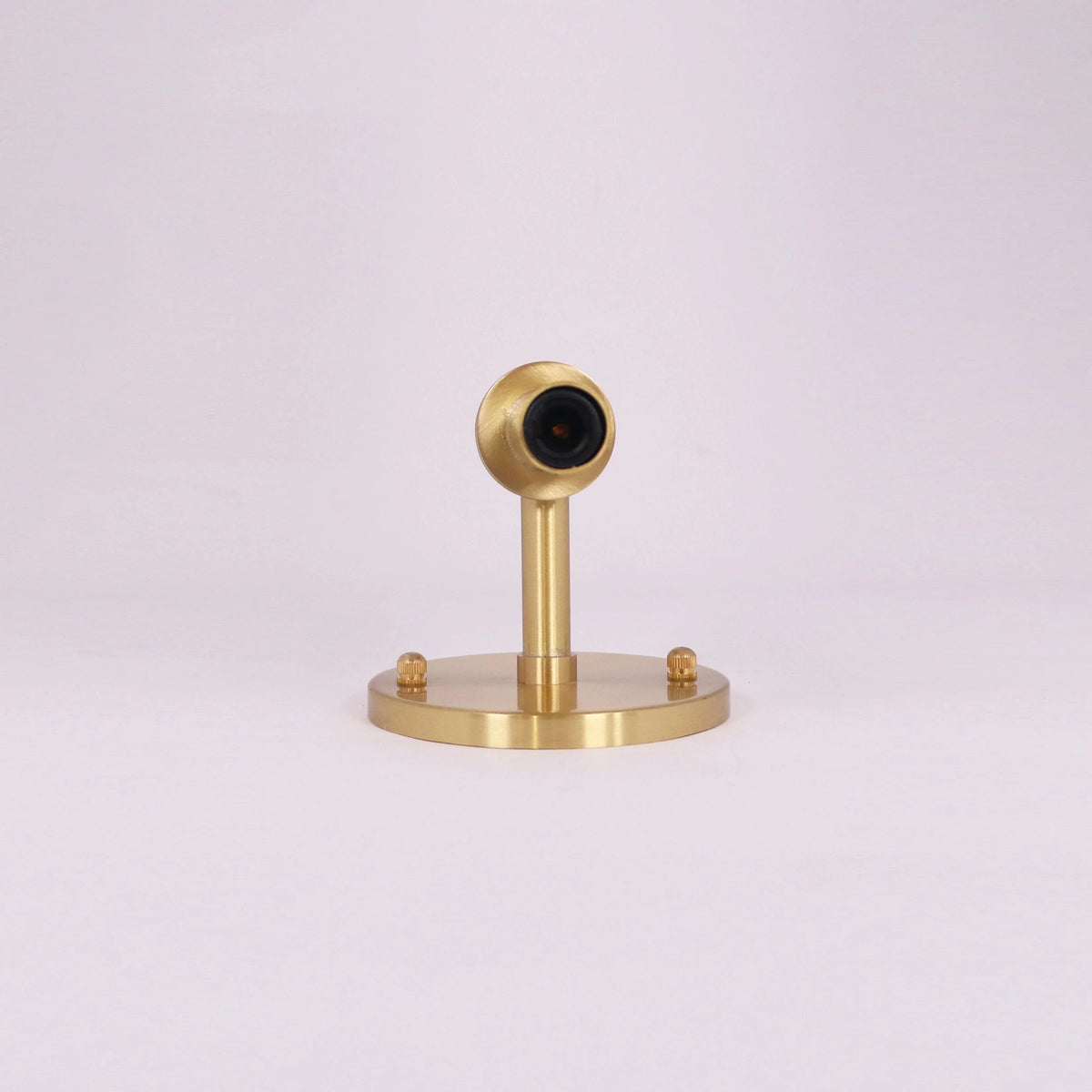 Brass modern lighting fixture with sleek design and circular base