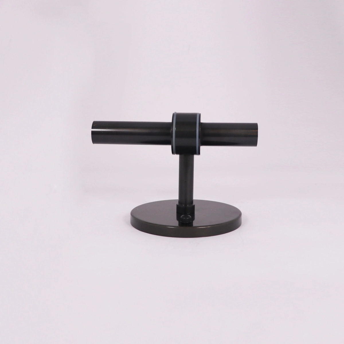Modern black T-shaped lighting fixture with sleek design and circular base
