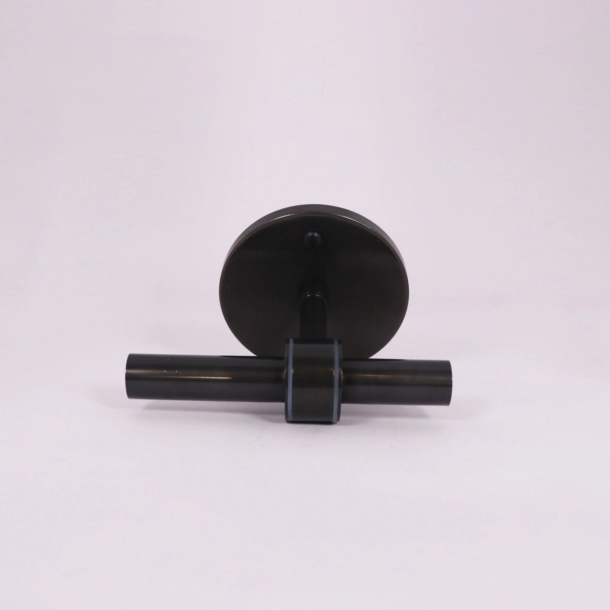 Modern black wall sconce with sleek cylindrical design and circular backplate