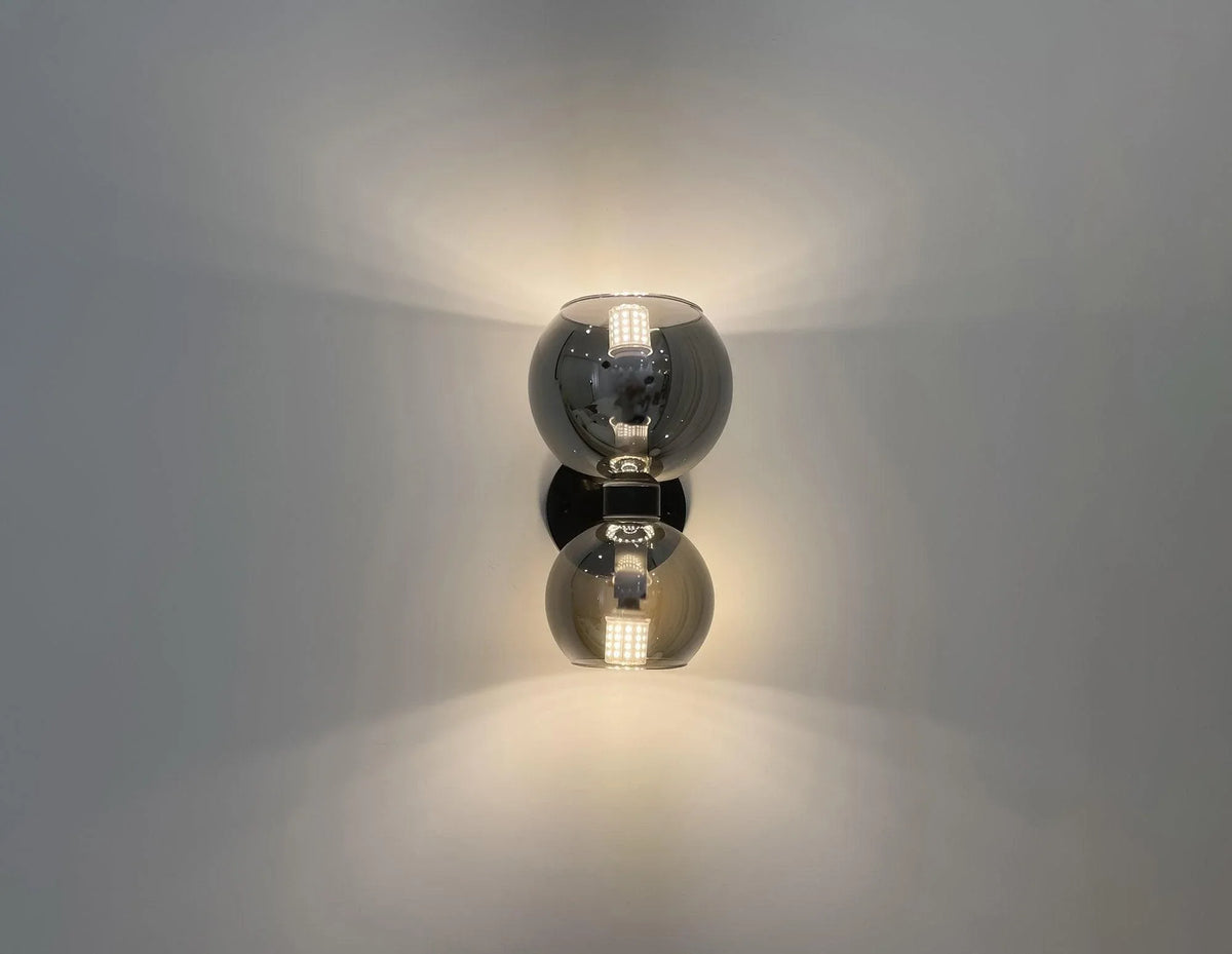 Modern double globe wall sconce with smoked glass shades and warm LED lighting for contemporary interiors