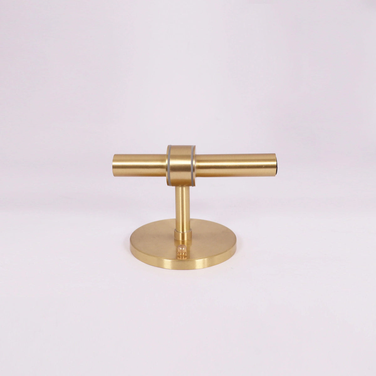 Modern brass T-bar table lamp with sleek design and circular base