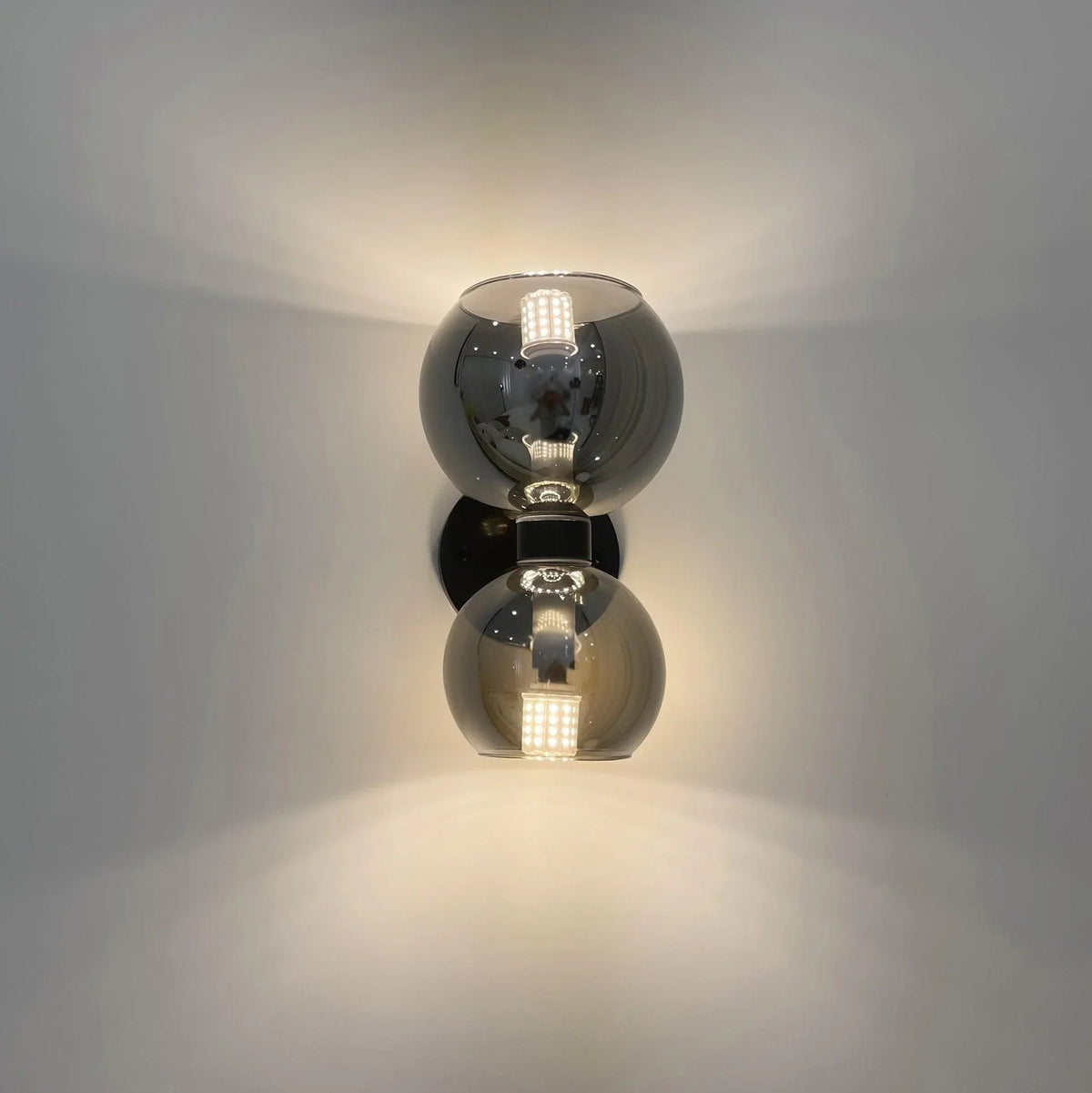 Modern crystal wall sconce with dual spherical shades and LED lighting