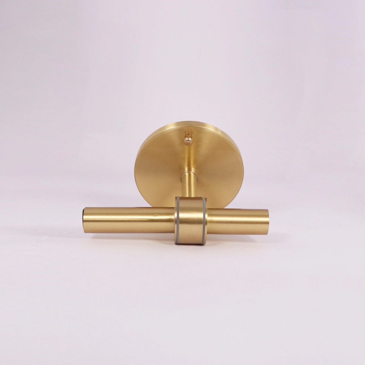 Modern brass wall sconce with sleek cylindrical design and brushed finish