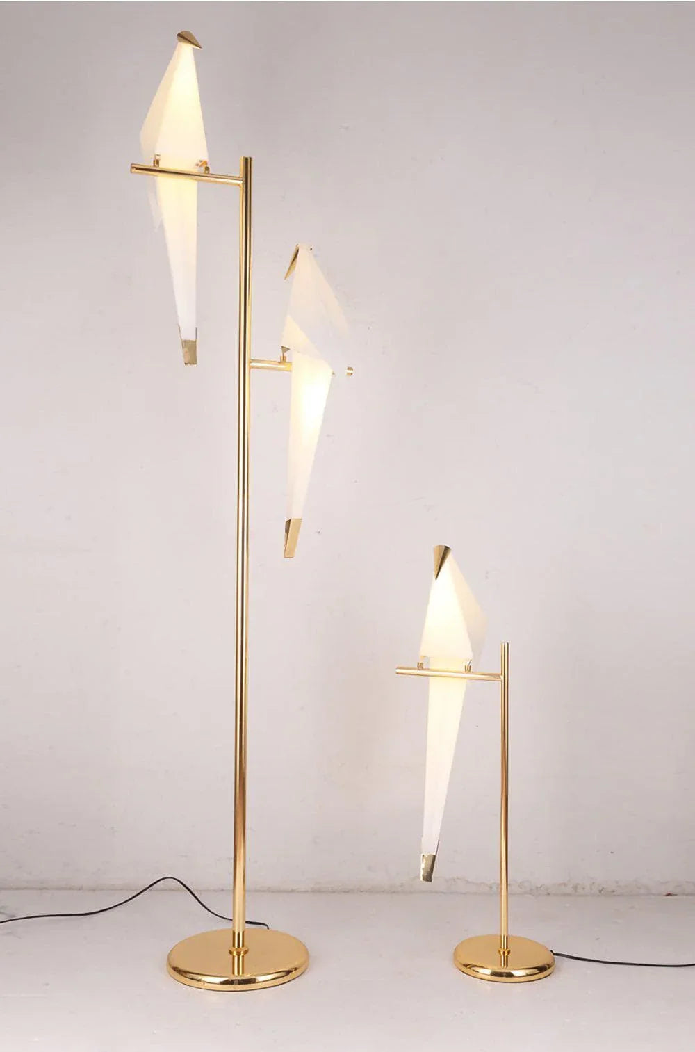 Modern gold floor and table lamps with geometric white shades, stylish contemporary lighting for living room or office